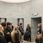 Tour guide explaining what Krakow was like before the war, at Schindlers museum Krakow